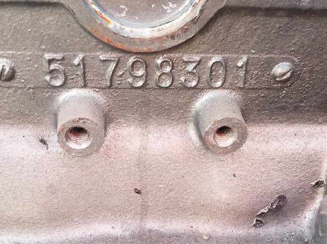 Close-up of OEM part identification tag on engine